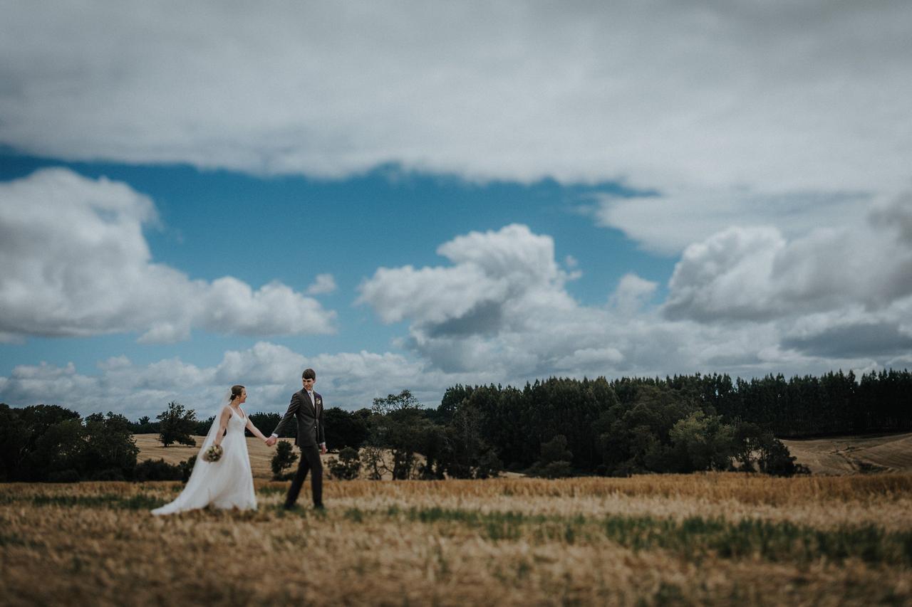 pareja recién casada caminando en el campo