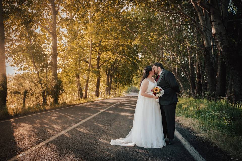 Novios besándose en la carretera